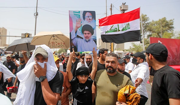 Supporters of Muqtada al-Sadr hold prayer near the parliament building in Baghdad, Iraq, Friday, Aug. 12, 2022 (AP Photo/Anmar Khalil)