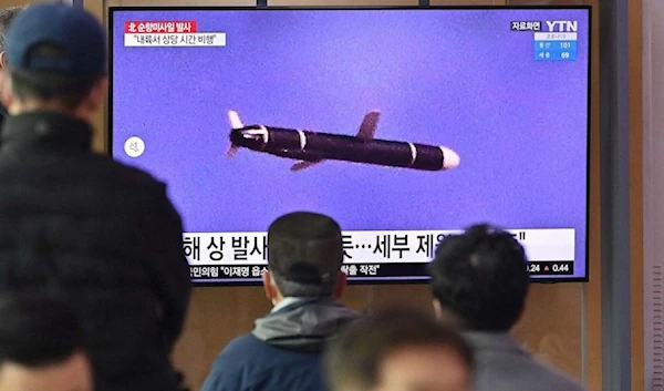 People watch a television screen showing a news broadcast with file footage of a North Korean missile test, at a railway station in Seoul on Jan. 25, 2022. (AFP)