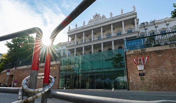 The sun sets behind the Palais Coburg where closed-door nuclear talks take place in Vienna, Austria, Friday, Aug. 5, 2022 (AP Photo/Florian Schroetter)