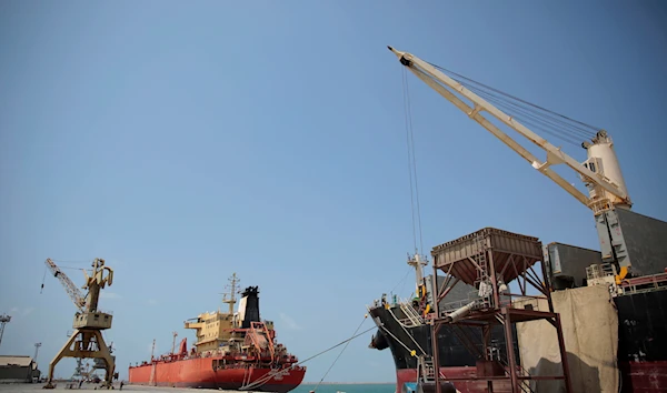 In this Saturday, Sept. 29, 2018 photo, a cargo ship and an oil tanker ship sit idle while docked at the port of Hodeida, Yemen. (AP Photo/Hani Mohammed)