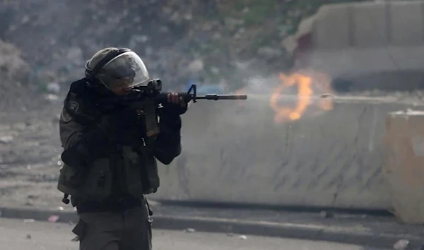 An Israeli soldier fires at a Palestinian demonstration (Archive)