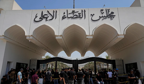 Supporters of Muqtada al-Sadr protest in front an entrance to the Supreme Judicial Council, in Baghdad, Iraq, Tuesday, Aug. 23, 2022 (AP Photo/Hadi Mizban)