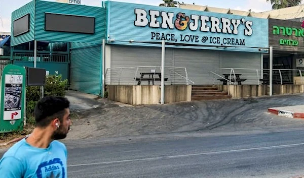 A man walks past a closed “Ben & Jerry’s” ice-cream shop in the Israeli city of Yavne, about 30 kilometres south of Tel Aviv, on July 23, 2021.