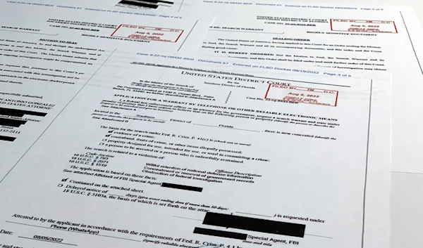 Documents related to the search warrant for former President Donald Trump's Mar-a-Lago estate in Palm Beach, Fla., are photographed Thursday, Aug. 18, 2022 (AP Photo/Jon Elswick)