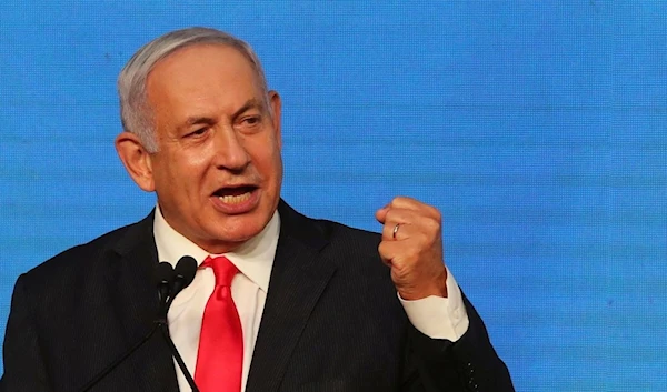 Then-Israeli occupation Prime Minister Benjamin Netanyahu at his Likud party headquarters in occupied Al-Quds, Palestine, March 24, 2021 (Reuters)