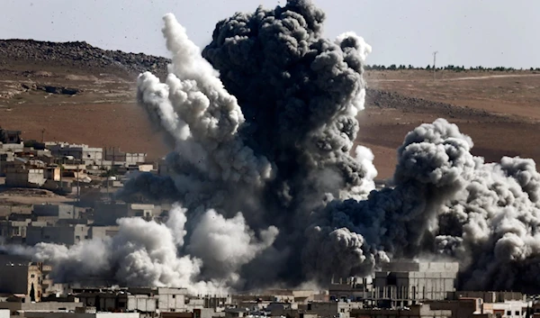 Smoke and dust rise over Syrian town of Kobani after an airstrike on October 22, 2014 (Reuters)