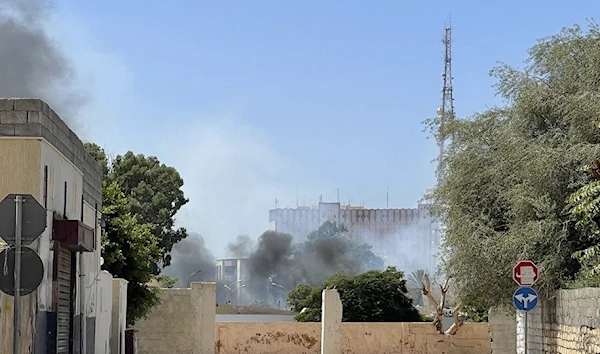 Smoke rises during an exchange of fire in the Libyan capital, Tripoli, August 27, 2022. (AFP)