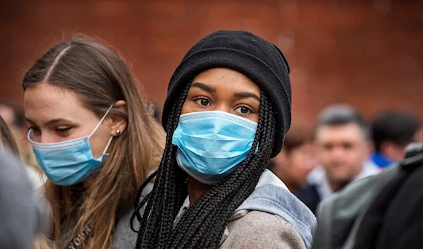 Young women wear face masks as protection against the coronavirus during Chinese New Year celebrations in London on January 26, 2020. (Getty Images)