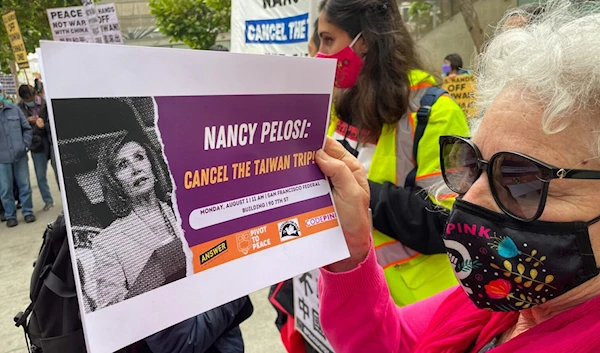 A protester holds a sign outside of the Federal Building in San Francisco, Calif. (The Standard)