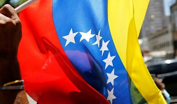 A man holding a Venezuelan flag during the May Day celebrations in Caracas (REUTERS)