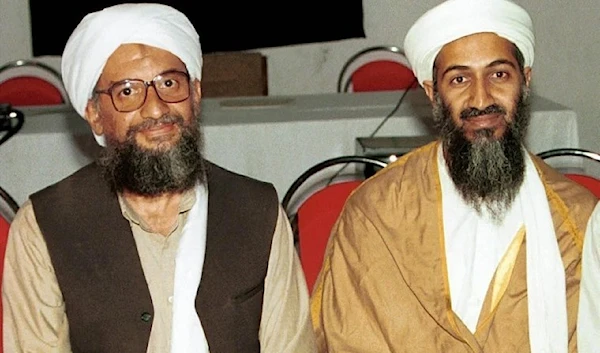 Al-Qaeda founder Osama bin Laden sits with his adviser Ayman Al-Zawahiri