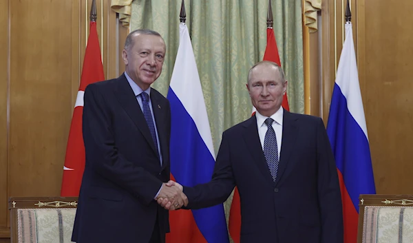 Turkish President Recep Tayyip Erdogan, left, and Russian President Vladimir Putin shake hands prior to their meeting at the Rus sanatorium in the Black Sea resort of Sochi, Russia, Friday, Aug. 5, 2022 ( Turkish Presidency via AP )