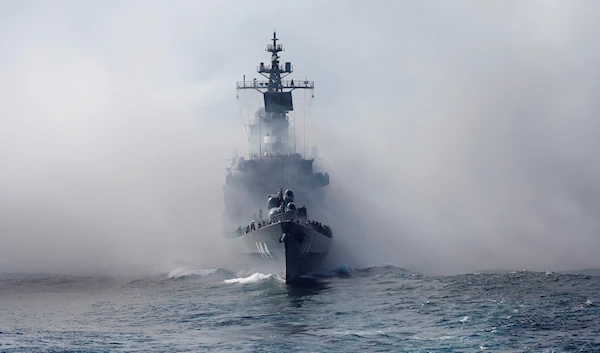 Japan Maritime Self-Defense Force (JMSDF) escort ship "Kurama" appears from the smoke during a fleet review in the waters off Sagami Bay, south of Tokyo, Japan, Sunday, Oct. 18, 2015 (AP Photo/Shizuo Kambayashi)