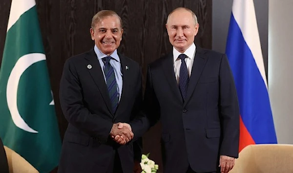 Russian President Vladimir Putin shakes hands with Pakistani Prime Minister Shehbaz Sharif during a meeting on the sidelines of the Shanghai Cooperation Organization (SCO) summit in Samarkand, Uzbekistan September 15, 2022. (Pool via REUTERS)