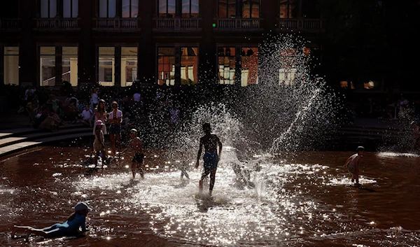 Children play in a fountain to beat the heat at the Victoria and Albert Museum in London, England, Friday, Aug. 12, 2022 (AP Photo/Manish Swarup)