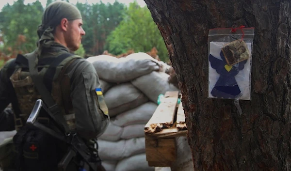 A member of the Ukrainian National Guard is seen at a position near a front line in Kharkov region (Reuters).