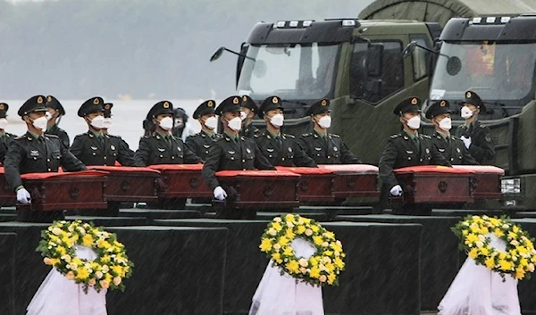 Soldiers escort coffins containing the remains of Chinese People's Volunteers (CPV) fallen soldiers.