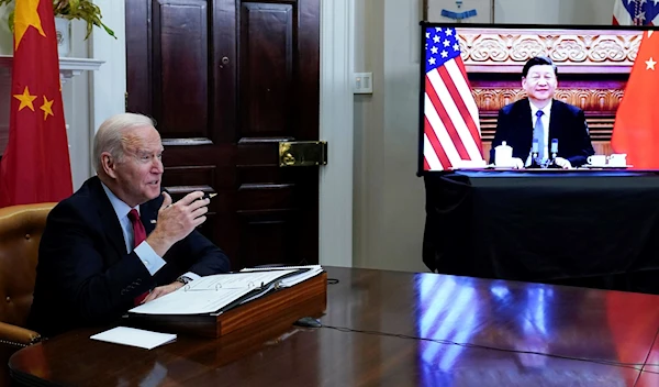 US President Joe Biden meets virtually with Chinese President Xi Jinping from the Roosevelt Room of the White House in Washington, on Nov. 15, 2021. (AP Photo/Susan Walsh, File)