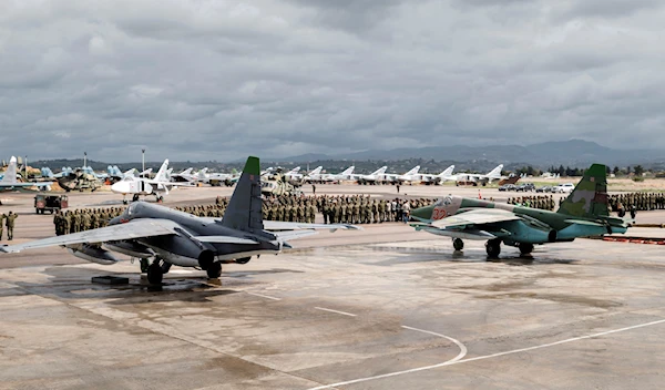 In this file photo provided on Tuesday, March 15, 2016, by the Russian Defense Ministry Press Service, a lineup of Russian troops is held at Hemeimeem air base in Syria (Vadim Grishankin/Russian Defense Ministry Press Service via AP, file)