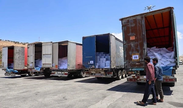 UN humanitarian aid trucks enter northwest Syria through the Bab al-Hawa border crossing with Turkey on June 1, 2021. © 2021 Associated Press.