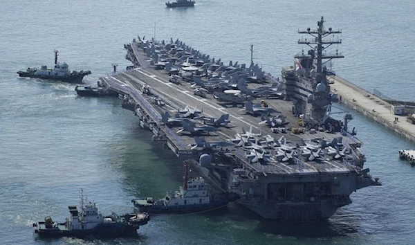 USS Ronald Reagan is escorted as it arrives in Busan, Friday (Yonhap)