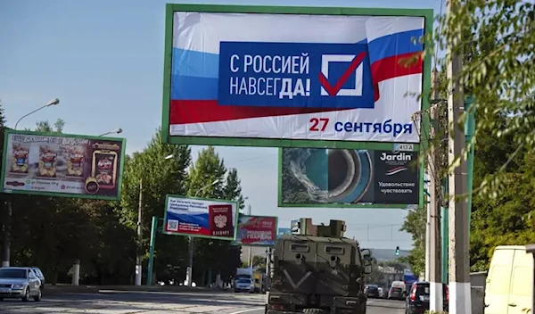 Billboard reads "With Russia forever, September 27" in LPR (AP)