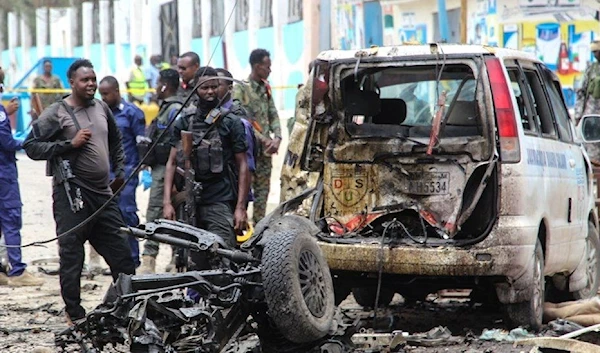 Security officers patrol on the site of a car-bomb attack in Mogadishu./ Getty Images.