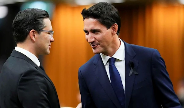 Prime Mnister Justin Trudeau and Liberal Party leader shaking hands with Conservative Party leader Pierre Poilievre after they both support both support the Bank of Canada’s restrictive monetary policy (The Canadian Press)