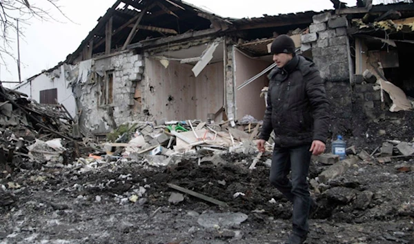 A man walking near a residential building that was damaged by shelling in Donetsk in 2015 (Archive))