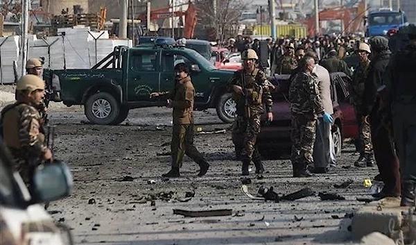 Afghan intelligence personnel inspect the site of a suicide attack along the Kabul-Jalalabad road in Kabul on November 27, 2014  (AFP)