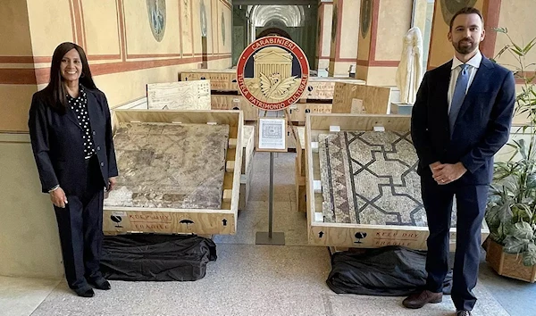 FBI agents pose with the 2,000 year old mosaic. Photo: FBI