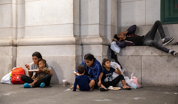 Families and solo migrants have a meal together after arriving at Union Station in D.C. on July 12 following a bus ride that originated in Texas. (Amanda Andrade-Rhoades for The Washington Post)