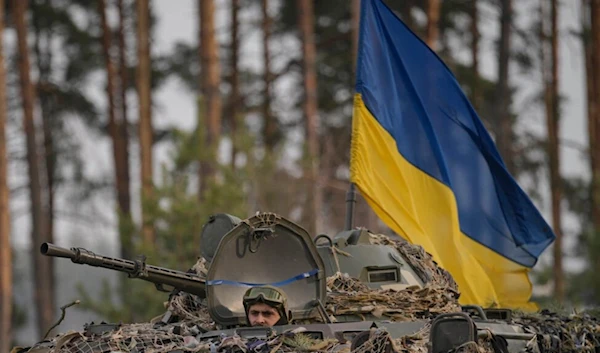 Ukrainian troops in an armored vehicle advance outside Kiev, Ukraine, March 31, 2022.