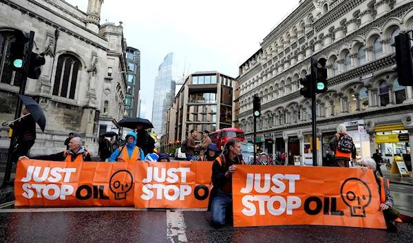 Activists from the group Just Stop Oil block a road in London, Thursday, Oct. 27, 2022 demanding to stop future gas and oil projects from going ahead (AP Photo/Kirsty Wigglesworth)