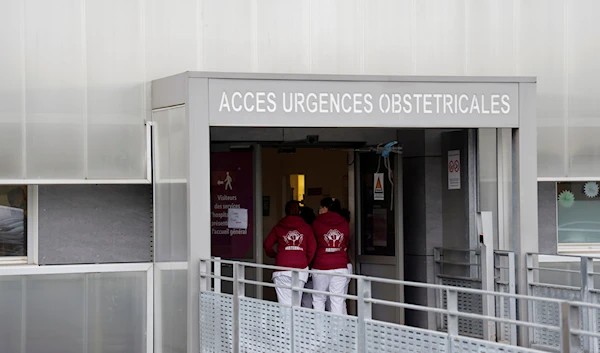 Health workers enter the Centre Hospitalier Sud Francilien Hospital in the southern Paris suburban city of Corbeil-Essonnes, Friday Jan. 6, 2023 ( Ludovic Marin, Pool via AP)