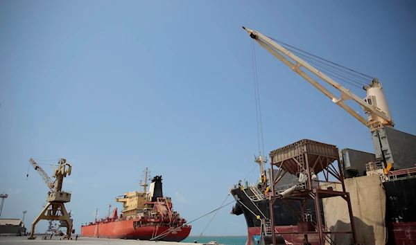 In this Saturday, Sept. 29, 2018 photo, a cargo ship and an oil tanker ship sit idle while docked at the port of Hodeida, Yemen (AP Photo/Hani Mohammed)