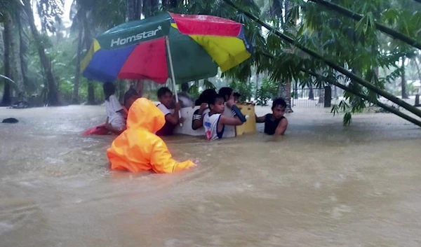 Children huddle up as rescue teams approach them (AP)