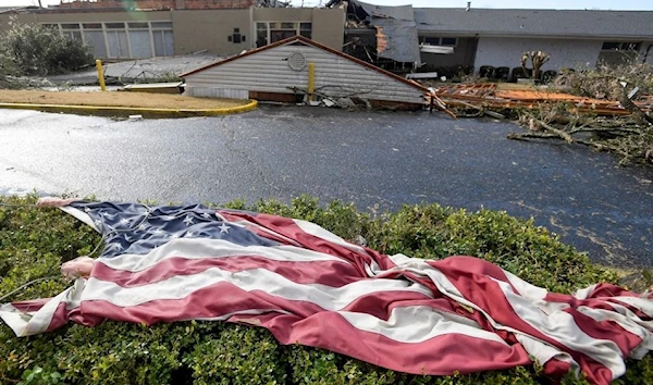 The American flag lies in the shrubs in front of the storm damaged Selma Country Club after a tornado ripped through Selma, Alabama, US, January 12, 2023. (REUTERS)