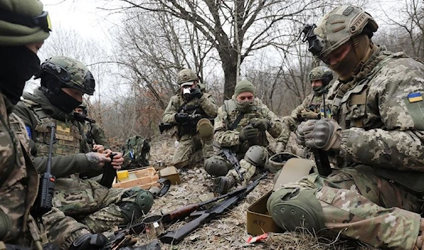 Members of the Ukrainian Territorial Defense Forces load magazines during tactical exercises, Ukraine, March 16, 2022. (REUTERS)