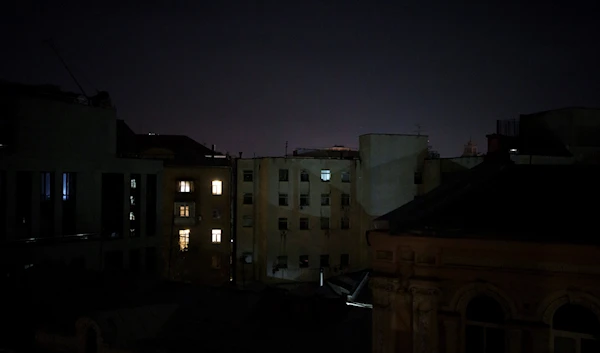 Some apartments are illuminated during a partial power outage in Kiev, Ukraine, December 31, 2022 (AP Photo)