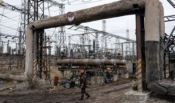 Workers at a power plant, try to repair damages after a Russian attack in central Ukraine, Thursday, Jan. 5, 2023 (AP Photo/Evgeniy Maloletka)