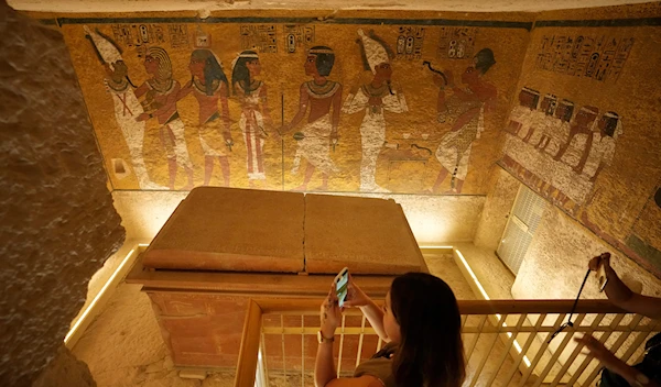 Tourists film the tomb of King Tutankhamun at the Valley of the Kings in Luxor, Egypt, Friday, Nov. 4, 2022 (AP Photo/Amr Nabil)