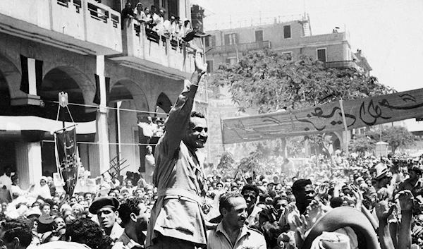 In this June 18, 1956 file photo, Egyptian leader Gamal Abdel Nasser waves as he moves through Port Said, Egypt, during a ceremony in which Egypt formally took over control of the Suez Canal from Britain (AP Photo, File)