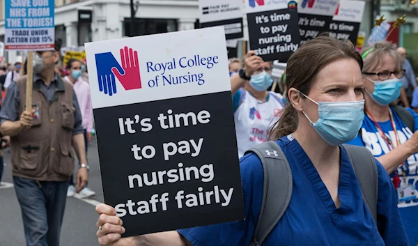 A nurse carrying a sign during the RCN protest in the UK in November (The Telegraph)