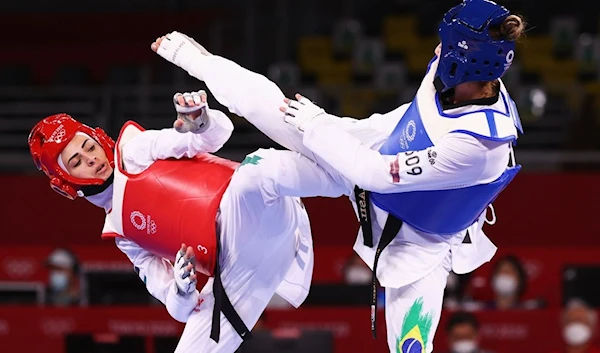 Milena Titoneli Guimaraes of Brazil in action against Julyana Al-Sadeq (left) of Jordan during the Taekwondo Women's Welterweight 57-67 kg at the Olympic Games (Reuters).