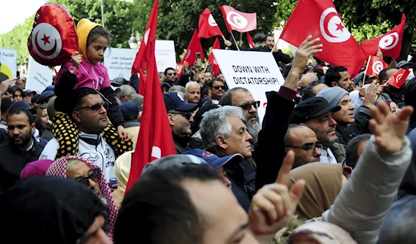 Tunisians gather during a protest against Tunisian President Kais Saied in downtown Tunis, Tunisia. Saturday Jan. 14, 2023 (AP).