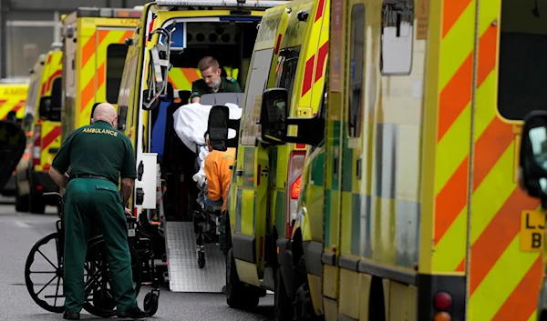 A patient is taken in to an ambulance as other ambulances wait outside the Royal London Hospital in east London, Wednesday, Jan. 4, 2023 (AP Photo/Alastair Grant)