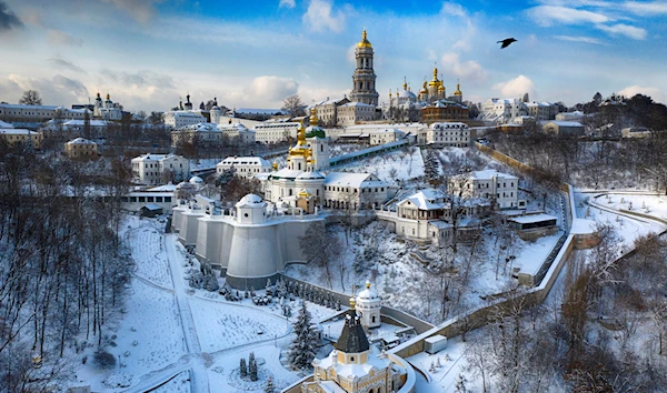 A bird flies over the sky near the 1000-year old Orthodox Pechersk Lavra monastic complex (Monastery of Caves) in Kyiv, Ukraine, on Jan. 15, 2021 (AP Photo/Efrem Lukatsky, File)