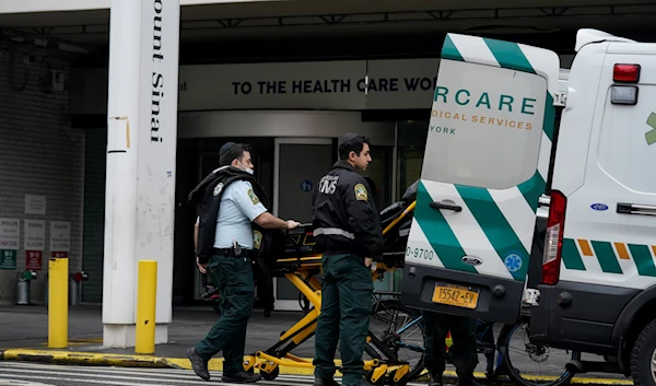 Emergency personnel load an ambulance in front of Mount Sinai Hospital in New York, Thursday, Jan. 12, 2023 (AP Photo/Seth Wenig)