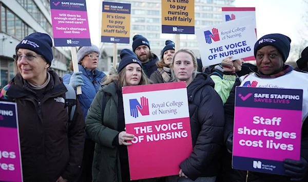 Members of the Royal College of Nursing stand on a picket line outside St. Thomas' Hospital in London on Thursday December 15, 2022.(Getty Images)